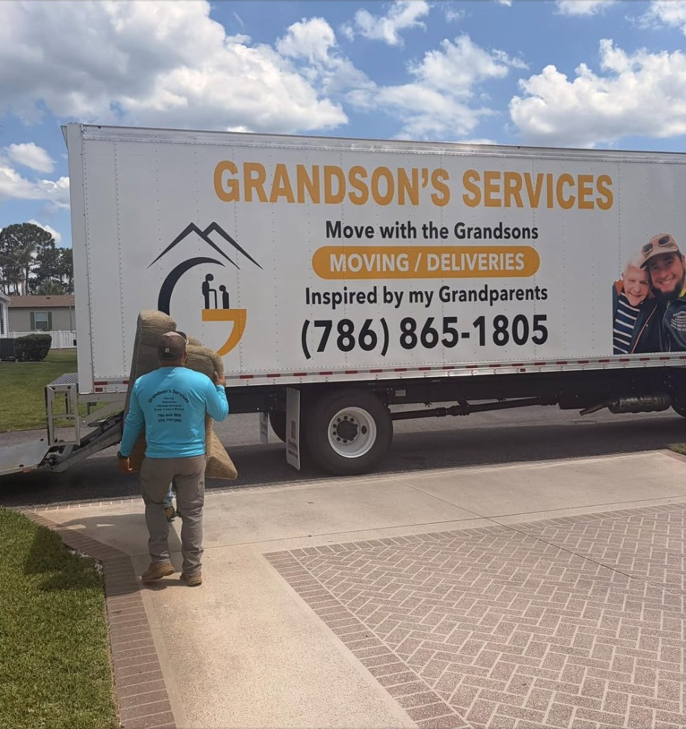 Grandson's Services moving truck unloading on a driveway